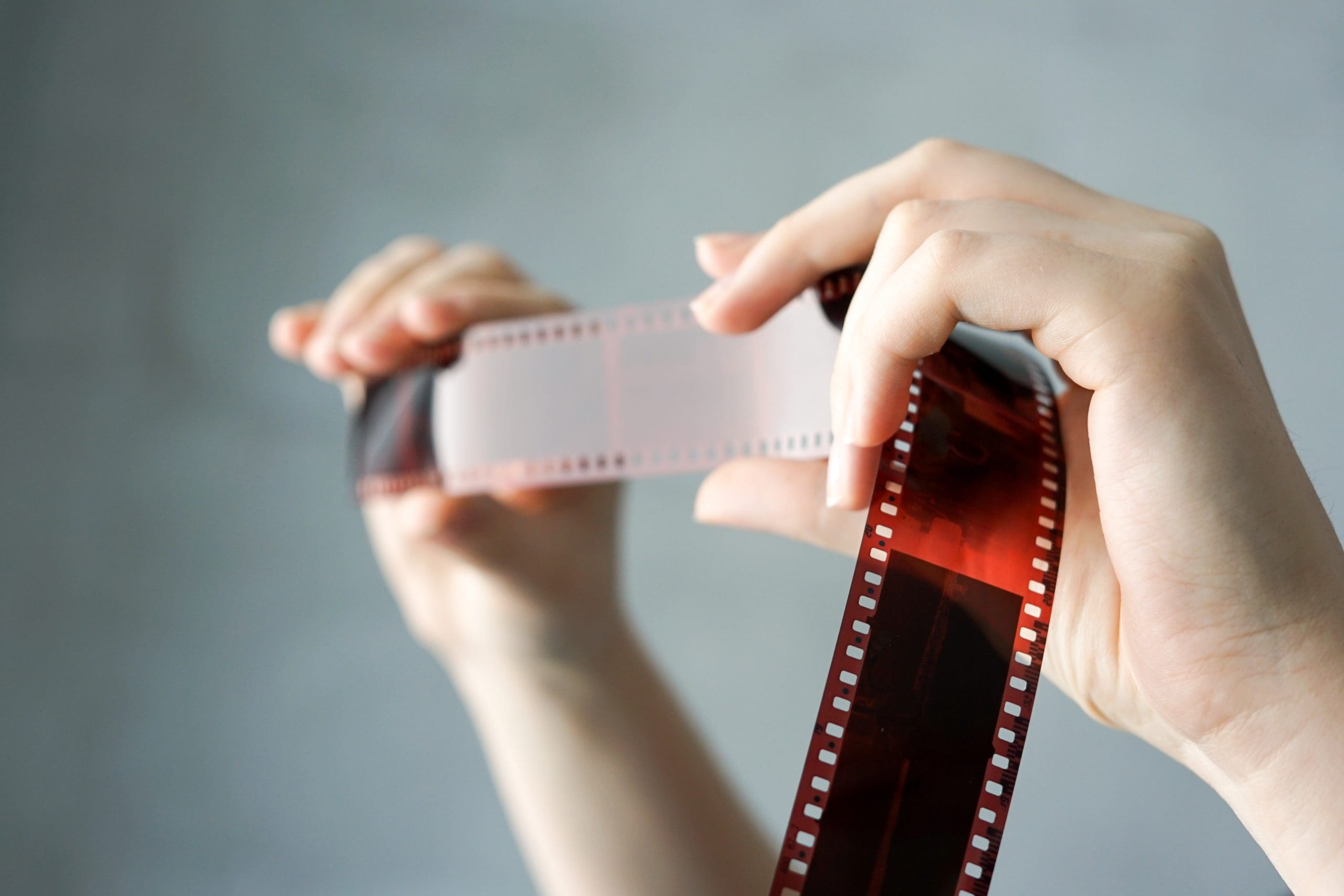 analog-photography-on-filmstrip-hands-holding-ph-2022-11-09-18-51-33-utc